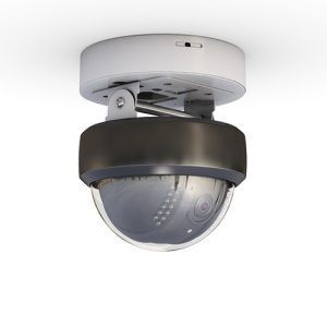 Circular white Ceiling Mount Security Camera installed in an indoor hallway.